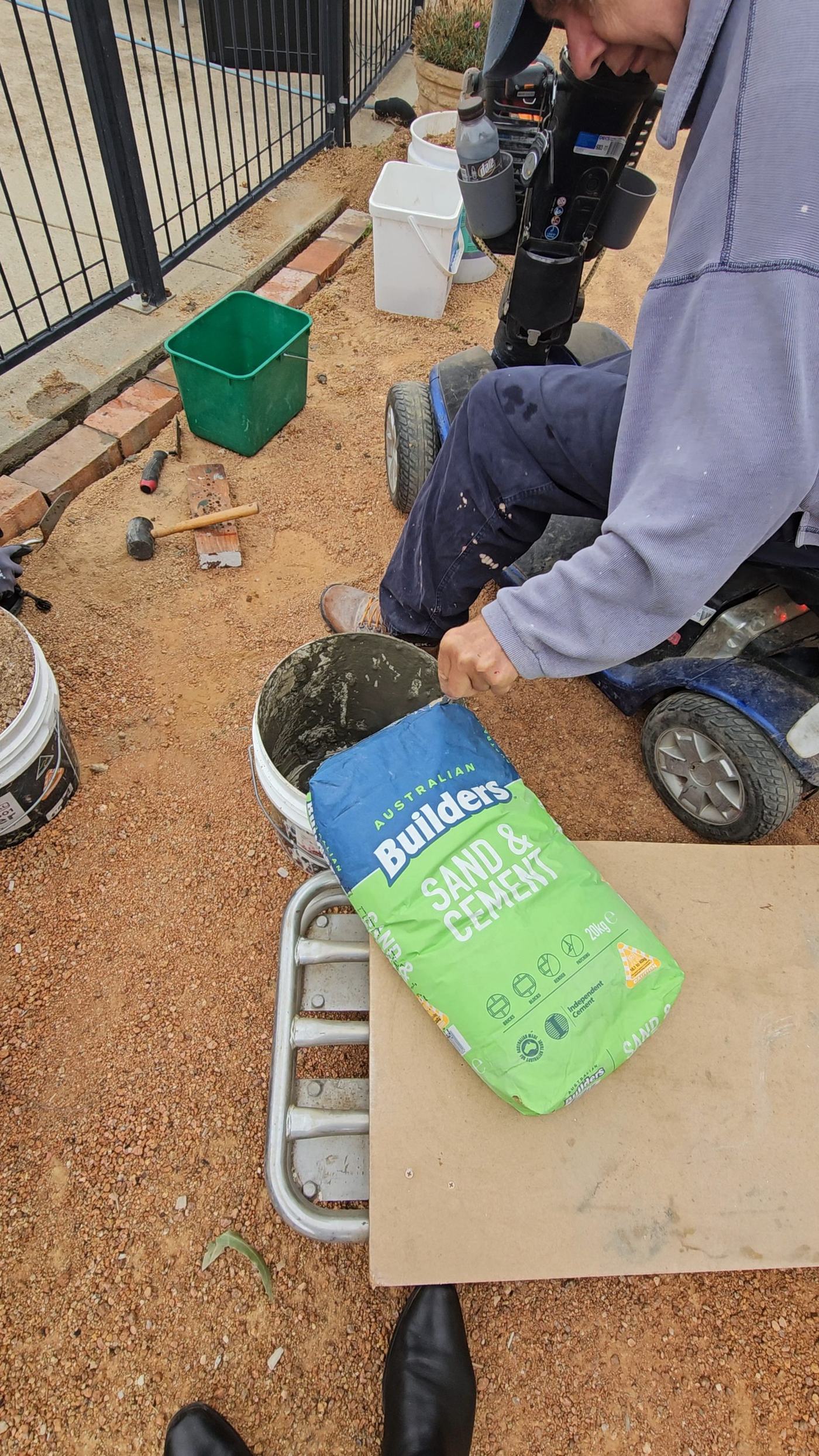Hands-on building work, mixing sand and cement for a project
